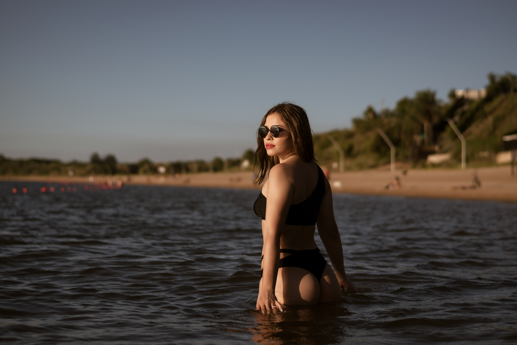 Shallow Focus of a Sexy Woman Wearing Black Bikini in the Water